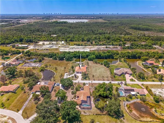 Aerial view featuring a water view and a wooded view