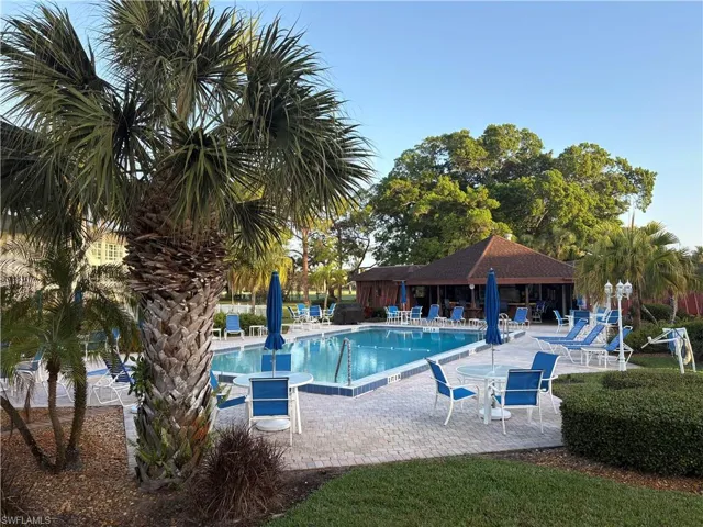 Community pool with a patio