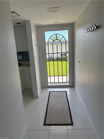 Entryway featuring a textured wall and tile patterned flooring