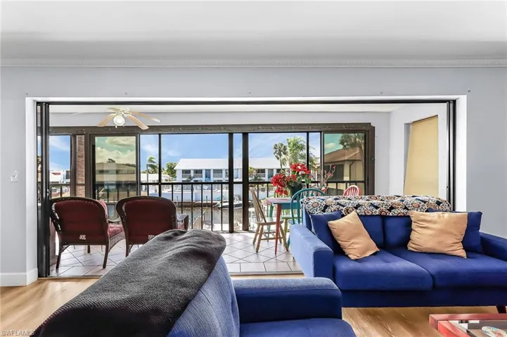 Living room featuring plenty of natural light, wood finished floors, and ceiling fan