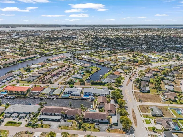 Aerial perspective of suburban area featuring a nearby body of water