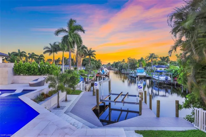 Dock area with boat lift and a water view