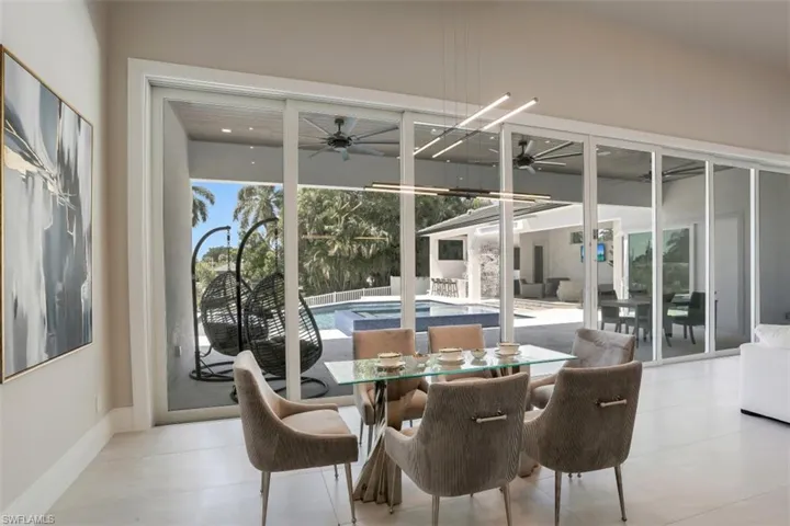 Dining space with ceiling fan and baseboards