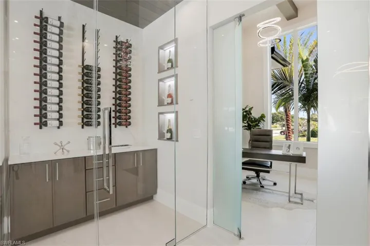 Wine area with healthy amount of natural light and light tile patterned flooring