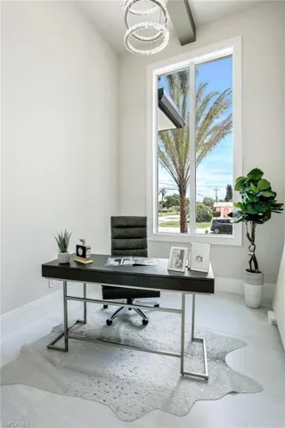 Office featuring baseboards and a chandelier