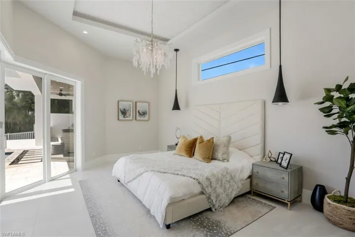 Bedroom with a chandelier and access to exterior