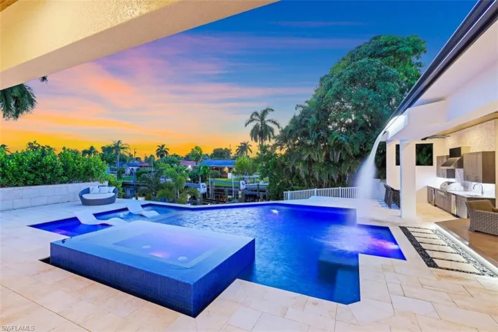 View of pool with area for grilling, a patio, a sink, and a pool with connected hot tub