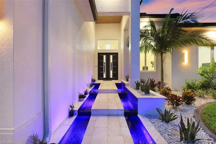 Property entrance featuring french doors and stucco siding