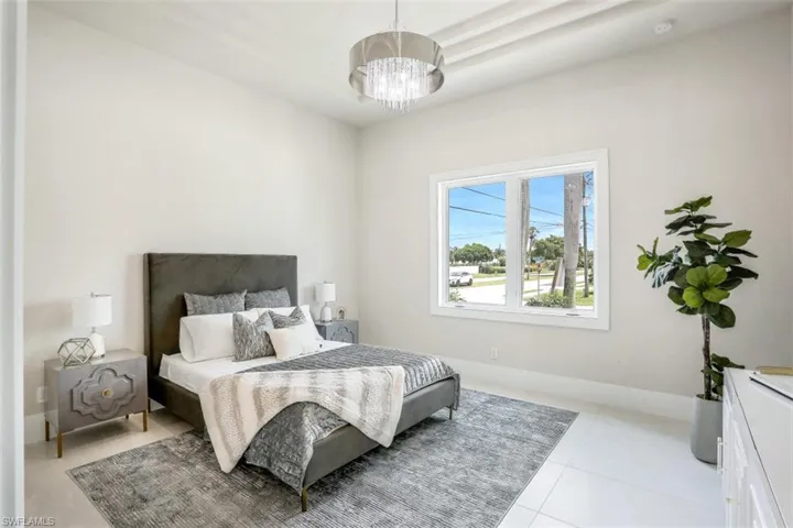 Bedroom featuring a chandelier and light tile patterned floors