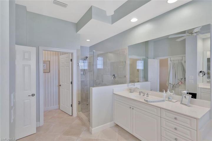 Double sink, frameless glass shower, soaking tub