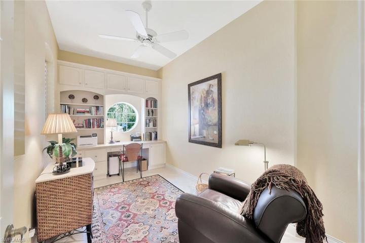 owner has this bonus room set up as an office with custom built-in desk, cabinets, book shelves and file drawers