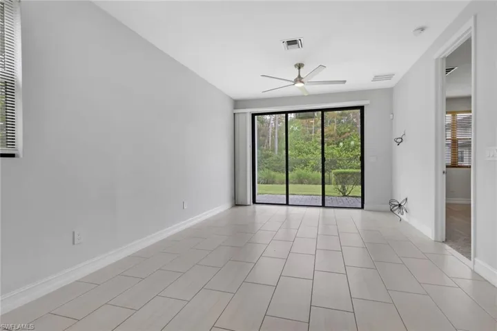 Unfurnished room featuring baseboards and ceiling fan