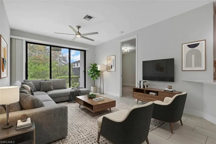 Living area with light tile patterned floors and a ceiling fan