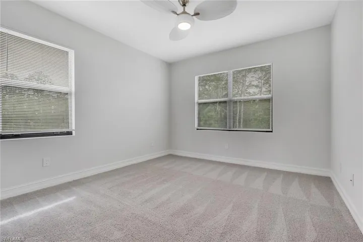 Unfurnished room with light carpet and a ceiling fan