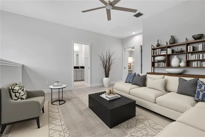 Living room with ceiling fan and light wood-style floors