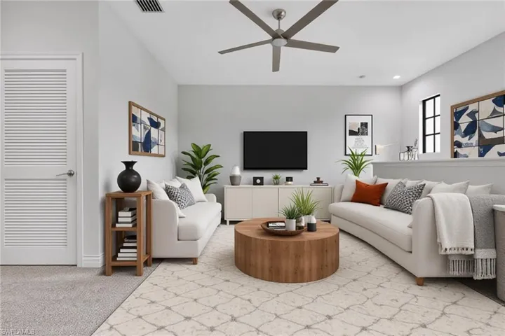 Living room featuring light colored carpet, ceiling fan, and recessed lighting
