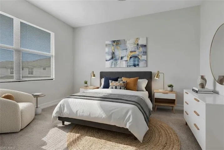 Bedroom featuring light carpet