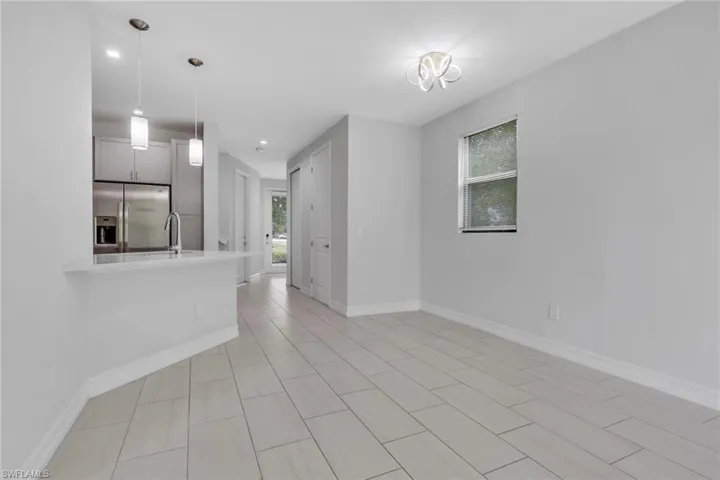 Unfurnished living room featuring baseboards