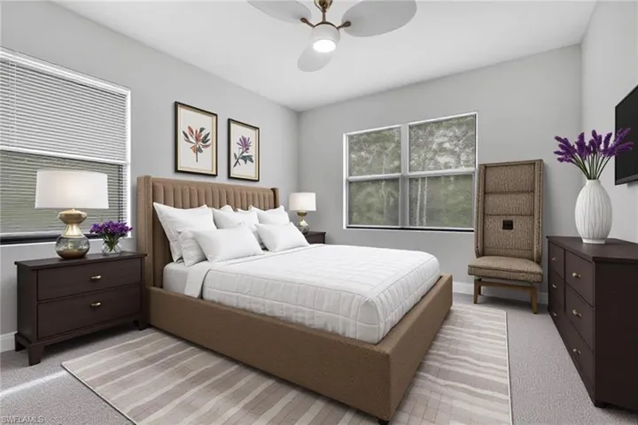 Carpeted bedroom featuring a ceiling fan and baseboards