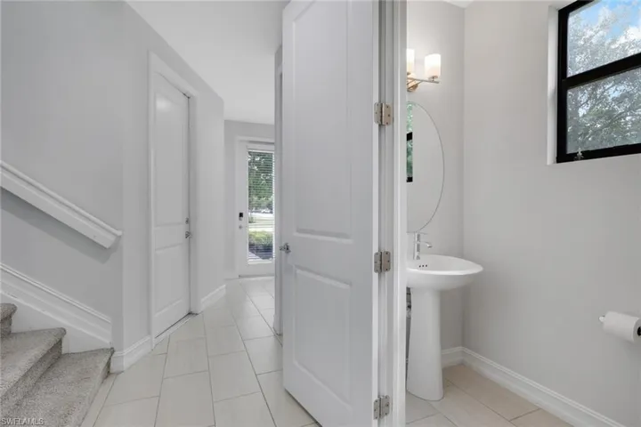 Half bathroom with light tile patterned flooring