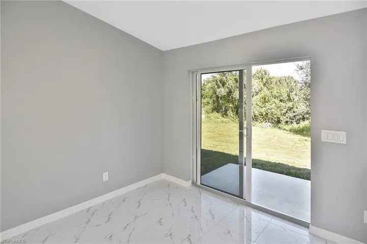 Doorway to outside featuring baseboards and marble finish floors