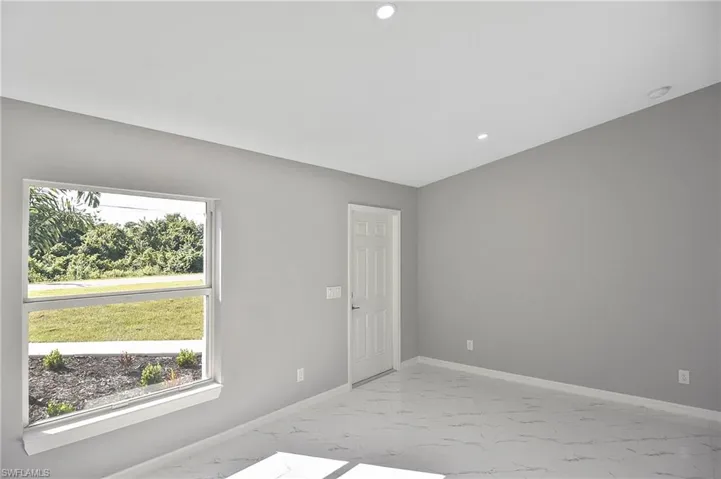 Unfurnished room with light marble finish flooring and recessed lighting