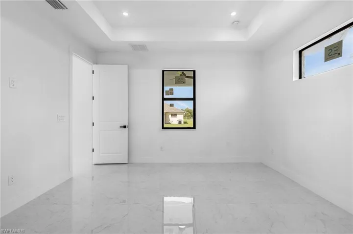 Spare room with a tray ceiling