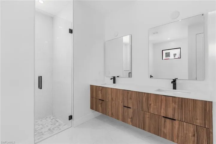 Bathroom featuring vanity and an enclosed shower