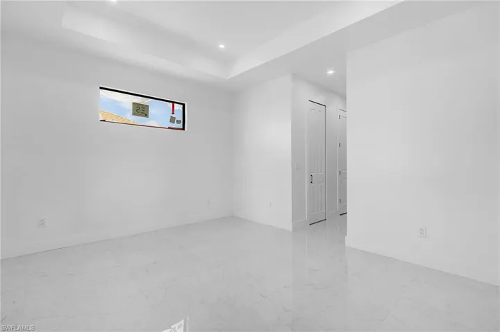 Unfurnished room featuring a tray ceiling