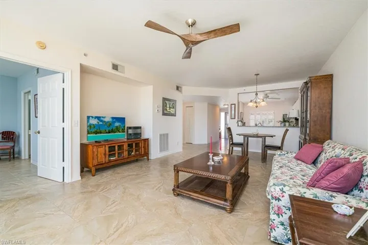 Living area featuring ceiling fan and hanging lights