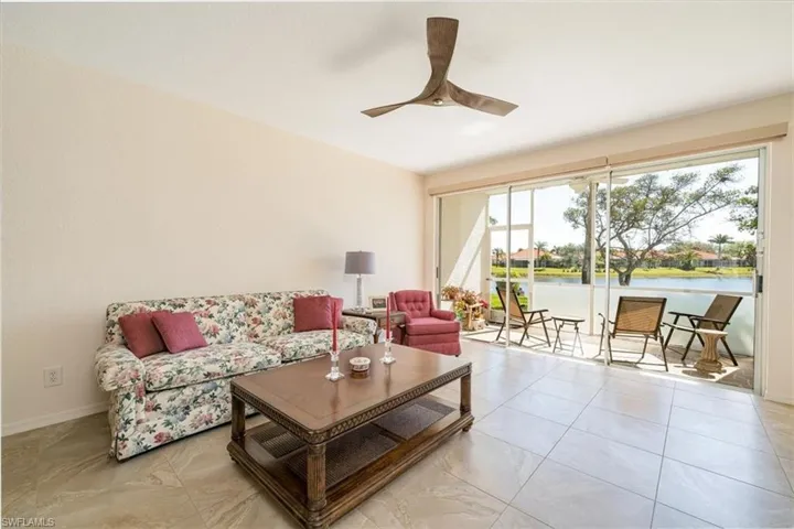 Living area featuring a water view and ceiling fan