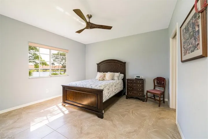Bedroom featuring ceiling fan and baseboards