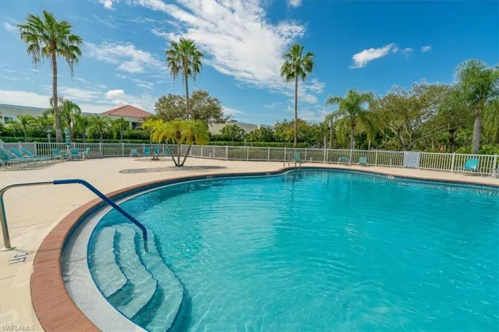 Community pool featuring a patio