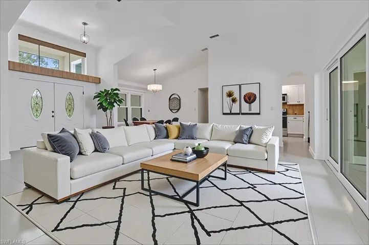 Living room with high vaulted ceiling and arched walkways