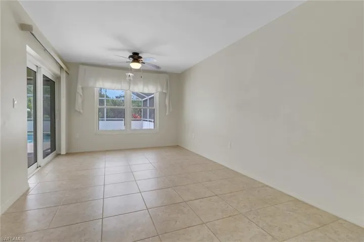 Unfurnished room with light tile patterned floors, baseboards, and a ceiling fan