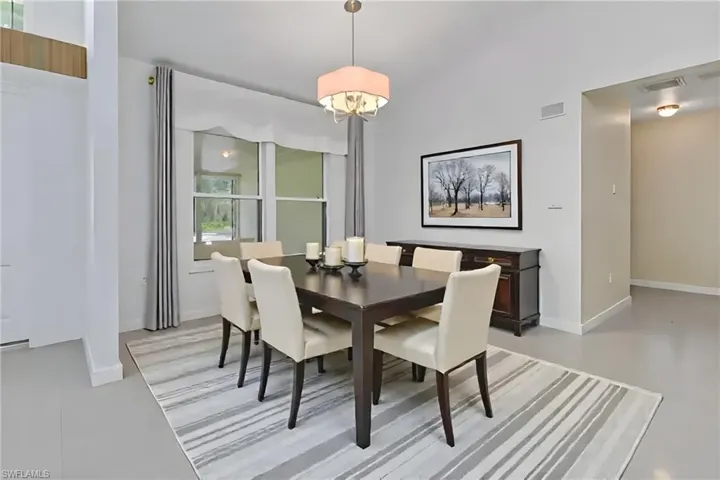 Dining area with baseboards and a chandelier