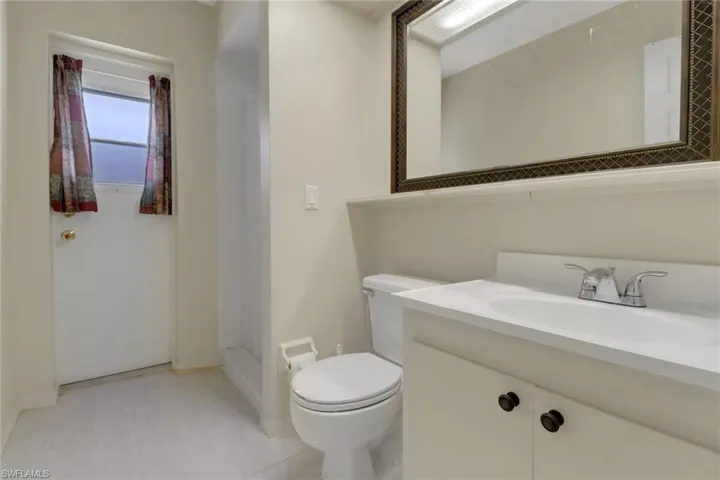 Full bathroom with a shower, vanity, baseboards, and toilet