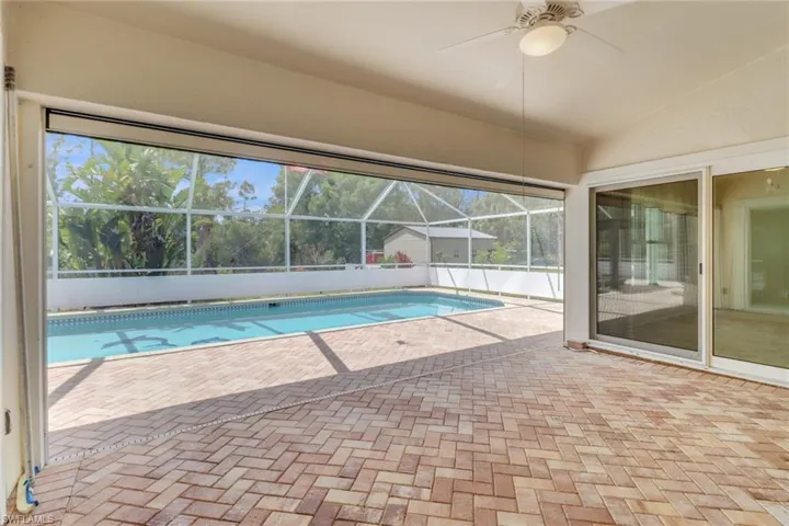 View of swimming pool featuring a fenced in pool, a patio area, a lanai, and ceiling fan