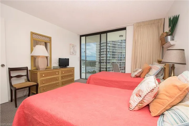 Carpeted bedroom with a textured ceiling and access to exterior