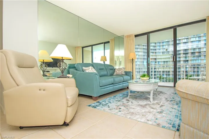 Tiled living room with expansive windows and plenty of natural light