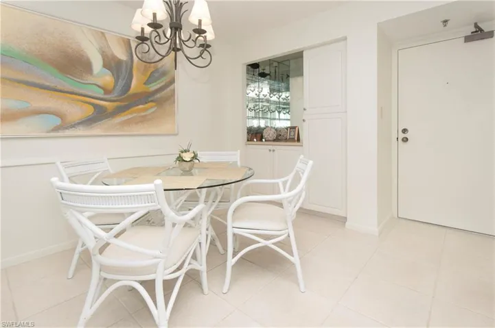 Tiled dining area with a notable chandelier