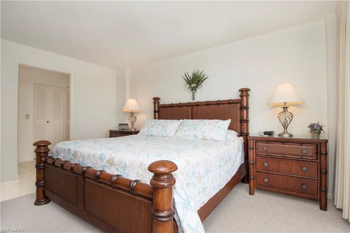 Bedroom featuring light colored carpet and a closet