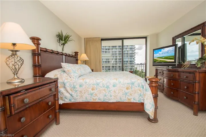 Bedroom with access to outside and light colored carpet