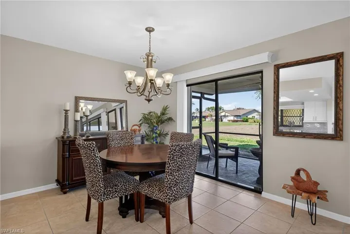 Dining space featuring a chandelier and light tile patterned flooring