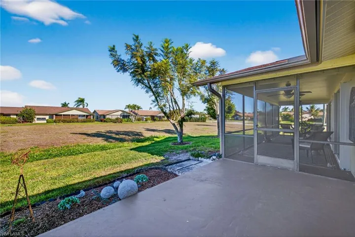 View of patio / terrace featuring a residential view, a ceiling fan, and a sunroom