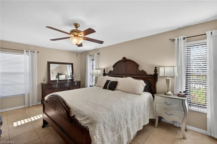 Bedroom featuring light tile patterned flooring and a ceiling fan