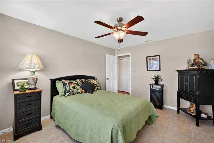Bedroom featuring light tile patterned floors and a ceiling fan