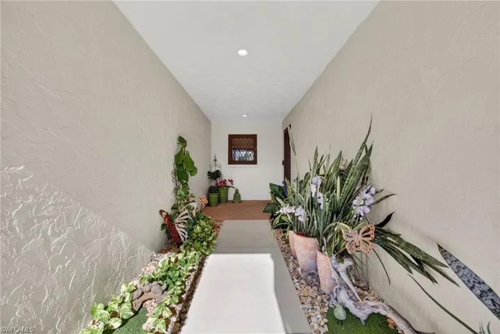 Property entrance featuring stucco siding