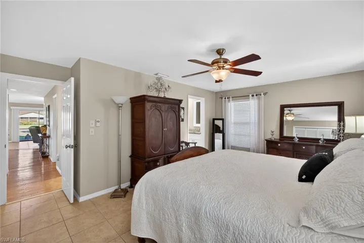 Bedroom featuring light tile patterned flooring and ceiling fan