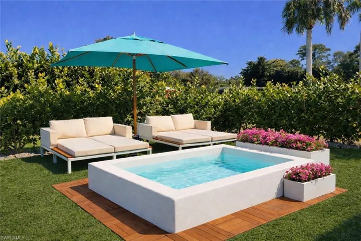 View of swimming pool with a hot tub and a yard